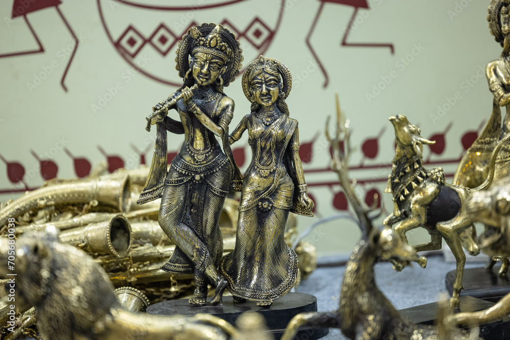Fototapeta premium Brass metal art, Handmade Indian God Krishna sculpture souvenir made with brass with plain background. Selective focus.