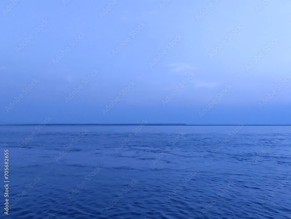 Obraz premium beautiful blue river, calm water, and sky photo background.