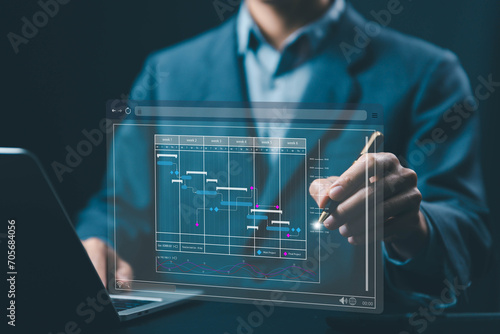 businessman schedule plan management shows a timeline Gantt chart in technology online. concept manage milestones, project planner in software, work update and workflow, appointment staff of business photo