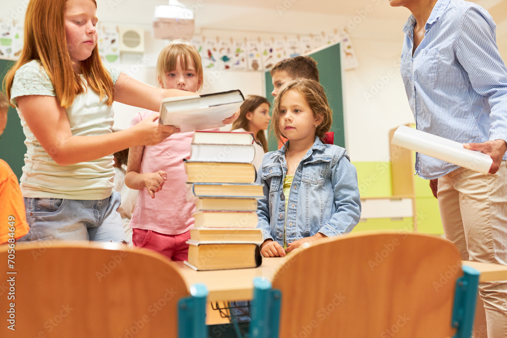 Students stacking books during activity at school