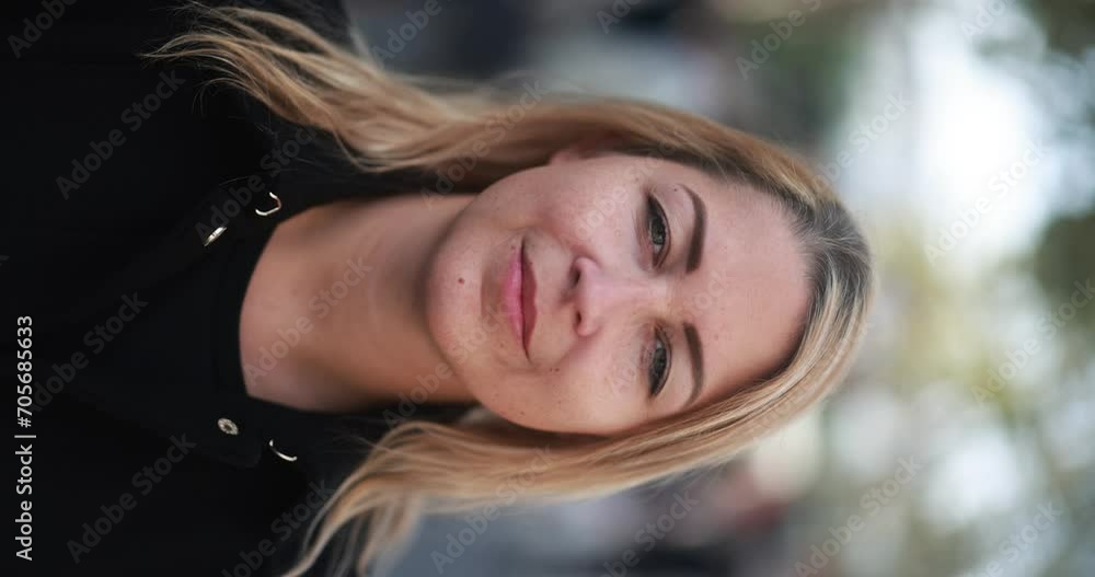 Young blonde woman looking on camera in the city - Vertical video Young blonde woman looking on camera in the city - Vertical video