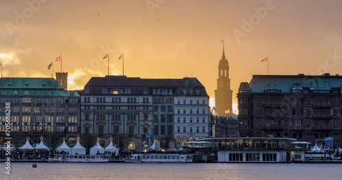 Time lapse Hamburg: view of Binnenalster (Inner Alster Lake) in golden and blue evening light at sunset, Hamburg, Germany, long exposure. St. Michael's Church, Hamburg, Germany, (German: Hauptkirche S photo