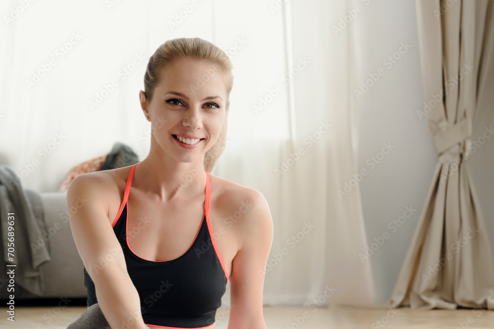 Smiling young woman in sportswear taking break after yoga class, After yoga, a smiling woman exudes tranquility in her sportswear. Smiling young woman in sportswear taking break after yoga class, After yoga, a smiling woman exudes tranquility in her sportswear.