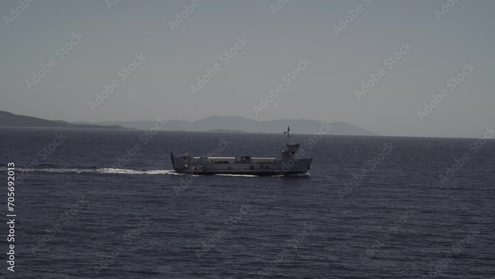 The ferry carries two trucks. Trucks sail by ferry to the island. Island logistics by sea. Shipping by sea. The ferry carries two trucks. Trucks sail by ferry to the island. Island logistics by sea. Shipping by sea.