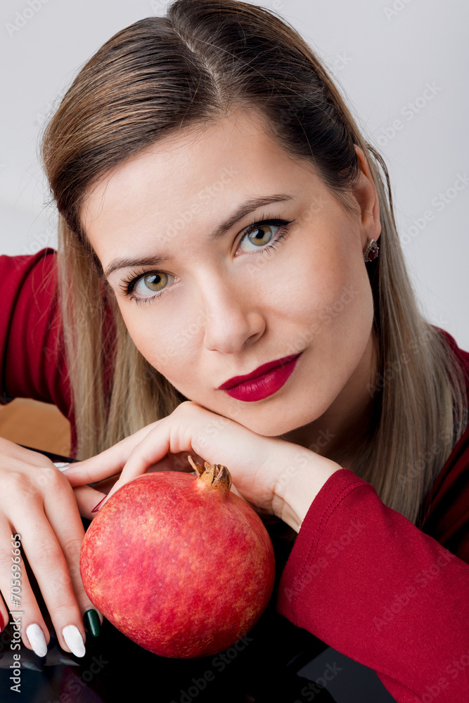 Beautiful Blonde with Red Lipstick and Pomegran Creative Makeup - Studio Concept on White Background Beautiful Blonde with Red Lipstick and Pomegran Creative Makeup - Studio Concept on White Background