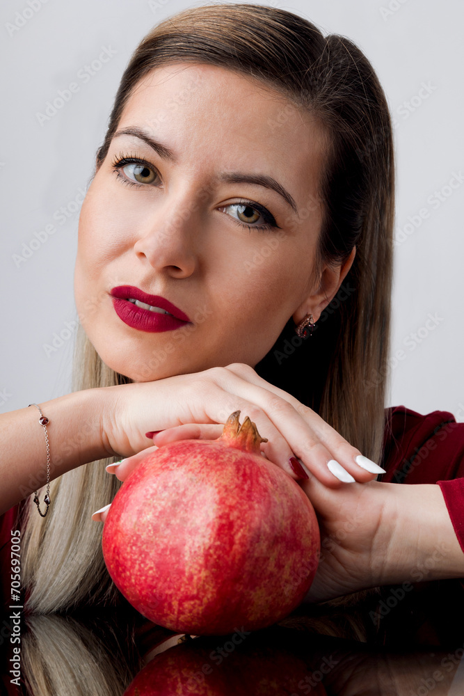 Beautiful Blonde with Red Lipstick and Pomegran Creative Makeup - Studio Concept on White Background Beautiful Blonde with Red Lipstick and Pomegran Creative Makeup - Studio Concept on White Background