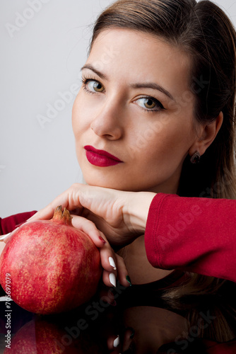 Beautiful Blonde with Red Lipstick and Pomegran Creative Makeup - Studio Concept on White Background photo