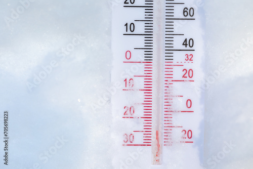 Outdoor thermometer in snow shows frigid winter temperature