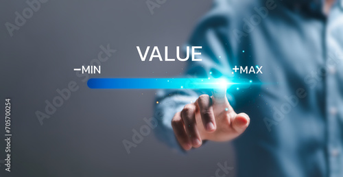 Businessman touch virtual screen of progress bar with the word VALUE for growth value, increase value, value added and business growth concept.