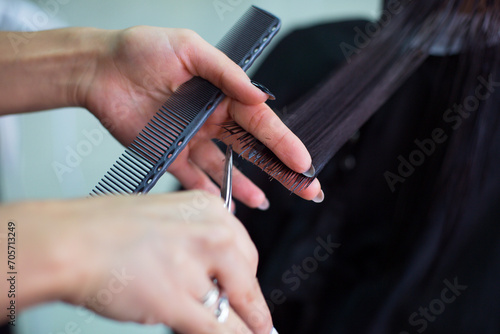 Hairdresser cutting client's hair in beauty salon. Beauty concept