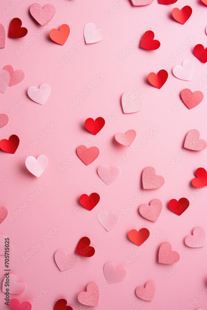 Valentine's day background with red and white hearts on pink background.