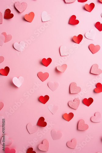 Valentine's day background with red and white hearts on pink background.