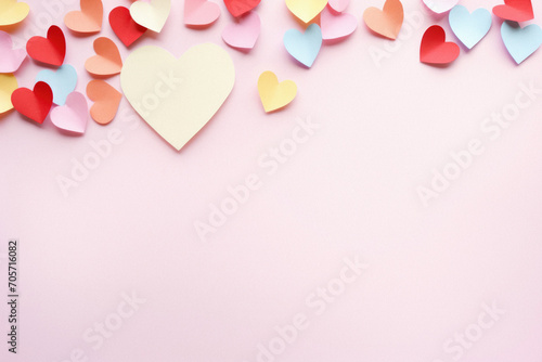Paper hearts on pink background with copy space. Valentines day background.