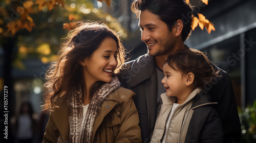 Urban Family Love: Mother, Father, and Child Embraced in the Romantic Glow of Evening Sun with Blurred Park Background