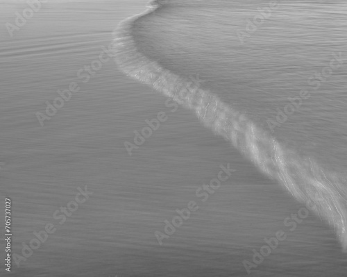 Folley Beach single wave rolling across the sand.  South Carolina. photo