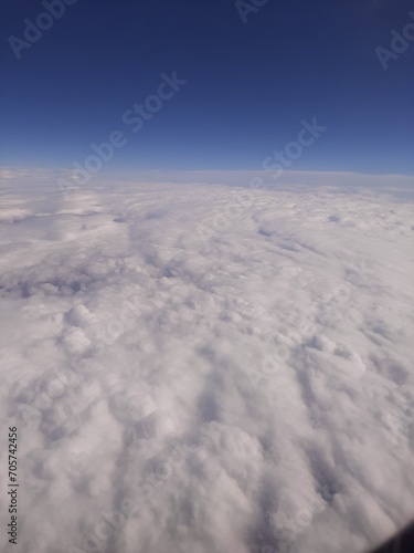 Fluffy clouds top view of the airplane Heavenly landscape