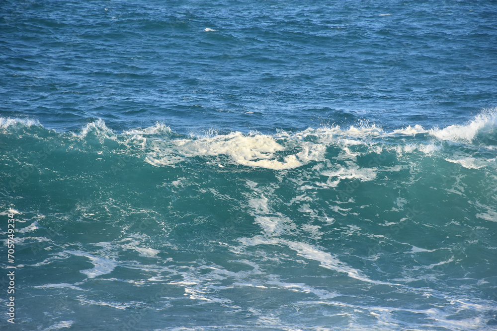 Blue sea water waves, in two different blue shades with foam. Waves texture background Blue sea water waves, in two different blue shades with foam. Waves texture background