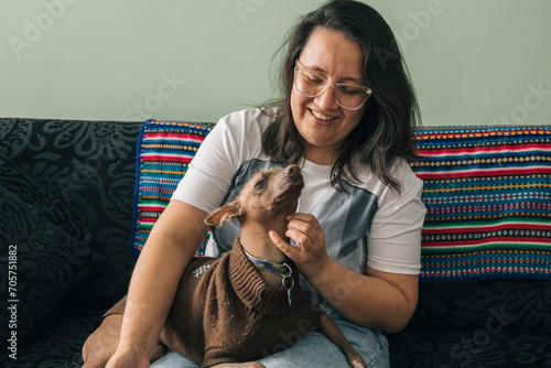 Woman petting her Peruvian viringo dog photo