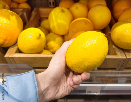 buying fruits(lemon, orange, tangerine, citrus, grapefruite)  at the market photo