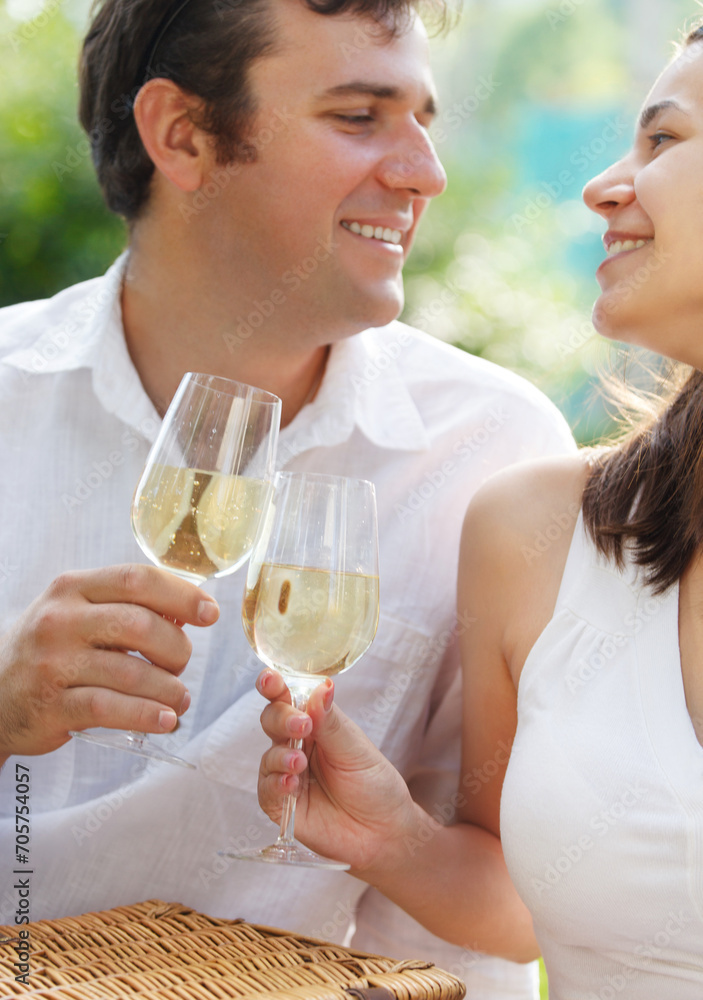 Young happy couple enjoying a glasses of white wine Young happy couple enjoying a glasses of white wine