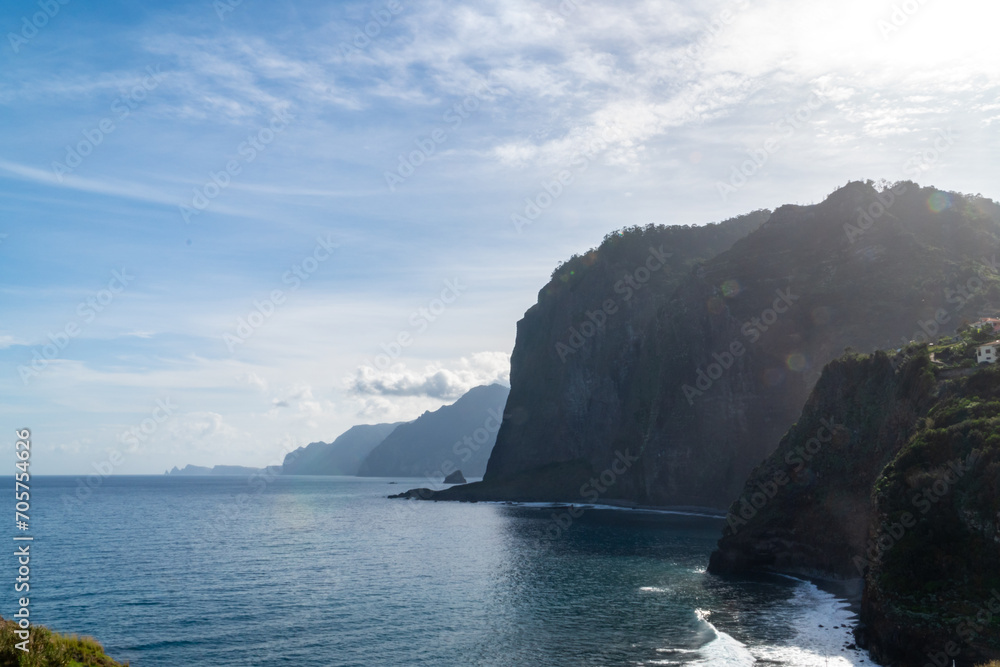 Waves crashing into the cliffs of madeira island