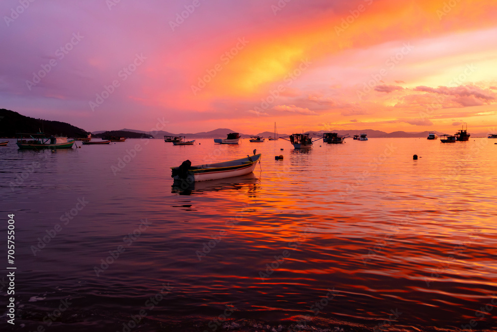 sunset over the sea with boats