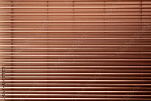  a close up of a window with a blind made out of wooden slats on the outside of the window and a cat sitting on the window sill in front of the window.