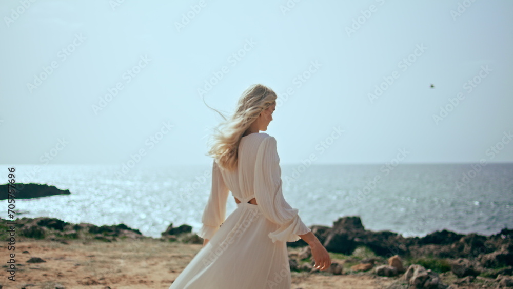 Gentle woman relaxing coast at beautiful sunset light. Girl walking ocean shore Gentle woman relaxing coast at beautiful sunset light. Girl walking ocean shore