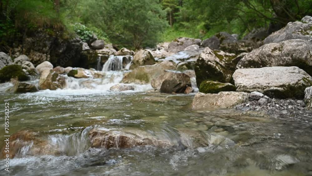 Waterflow of a rocky mountain stream after sunset in summer Waterflow of a rocky mountain stream after sunset in summer