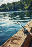 Fishing rod, spinning reel on the background of the pier on the river bank.