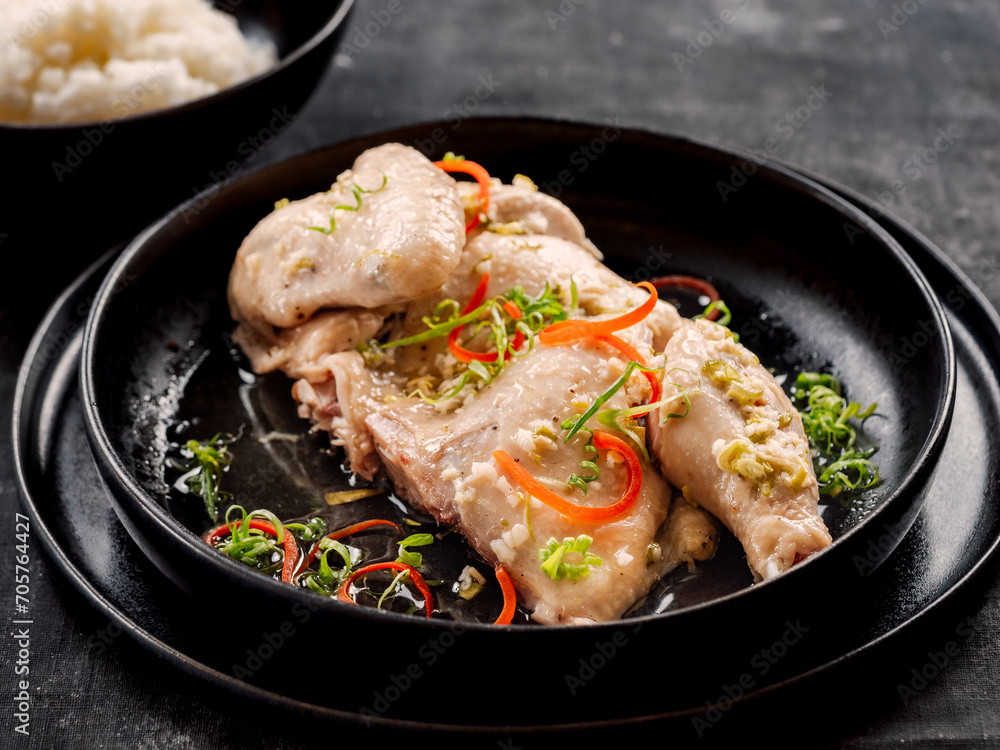 Sous Vide Chicken with spices. Boiled chicken sous-vide on black plate. Sous-vide is culinary method of long-term cooking Sous Vide Chicken with spices. Boiled chicken sous-vide on black plate. Sous-vide is culinary method of long-term cooking