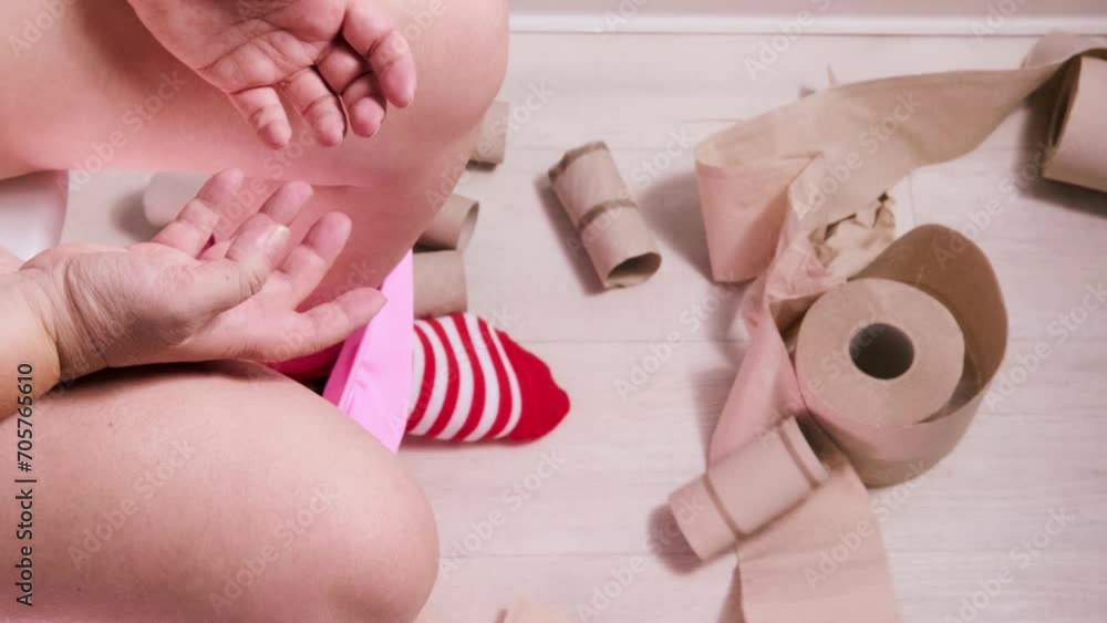 woman sitting on toilet with toilet paper and suffering from