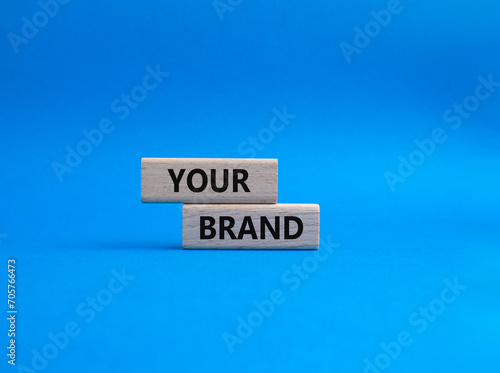 Your Brand symbol. Concept word Your Brand on wooden blocks. Beautiful blue background. Business and Your Brand concept. Copy space