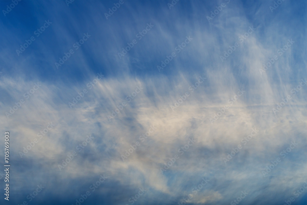 Traces of airplanes spread across the sky, stretching over huge ...