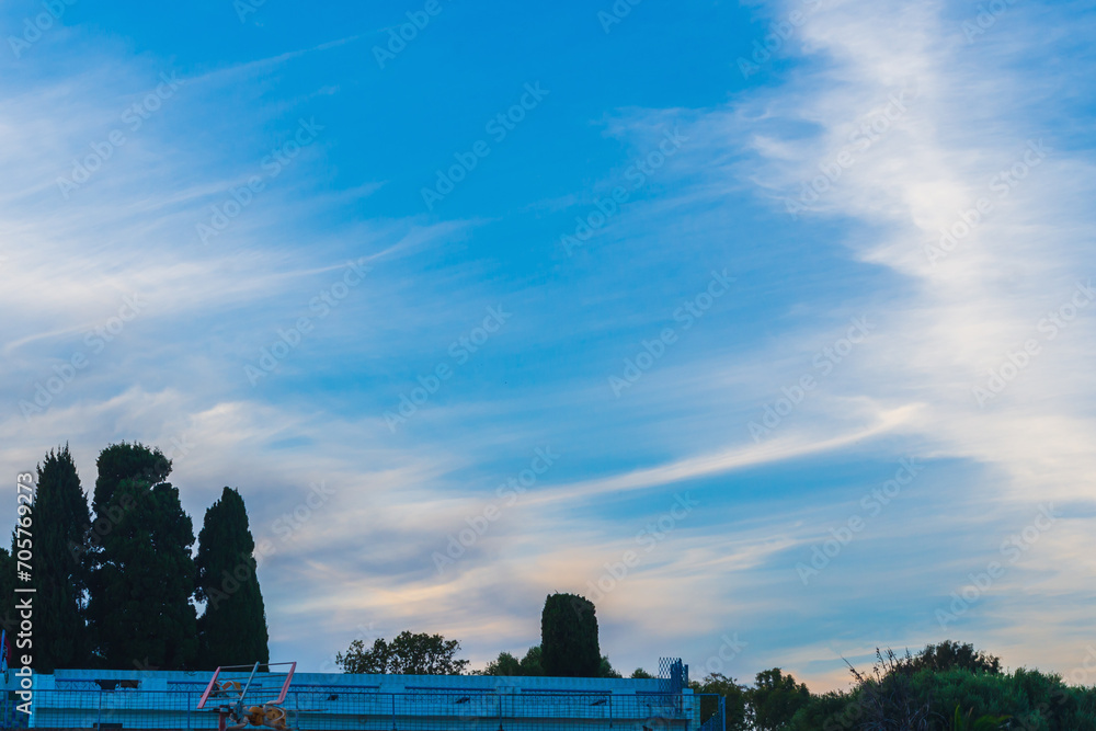 Fototapeta premium Traces of airplanes spread across the sky, stretching over huge distances, concept about the impact of the climate change program on nature