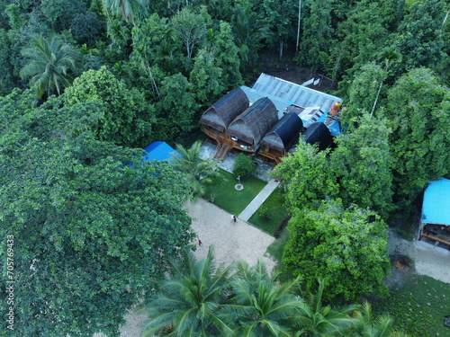 View of a Green Urban Jungle with Empty Buildings and Lush Foliage, 'air belanda resort' in sawai saleman, maluku, indonesia
