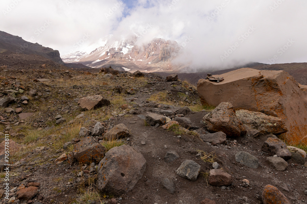 Mount Kazbegi in Georgia Caucasus mountains with snow and fog