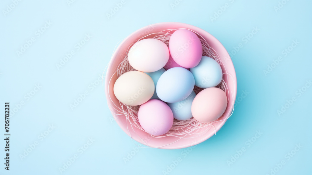 Easter eggs in pastel blue and pink colors, in a pink bowl on a blue background Easter eggs in pastel blue and pink colors, in a pink bowl on a blue background