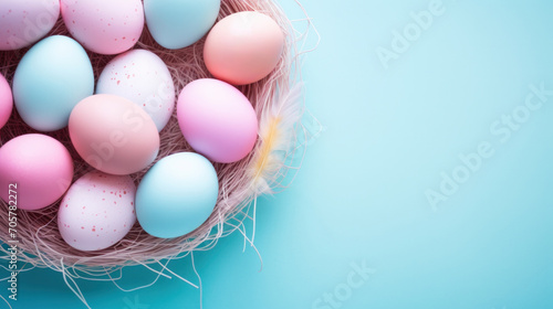 Easter nest with eggs in pastel blue and pink colors on a blue background