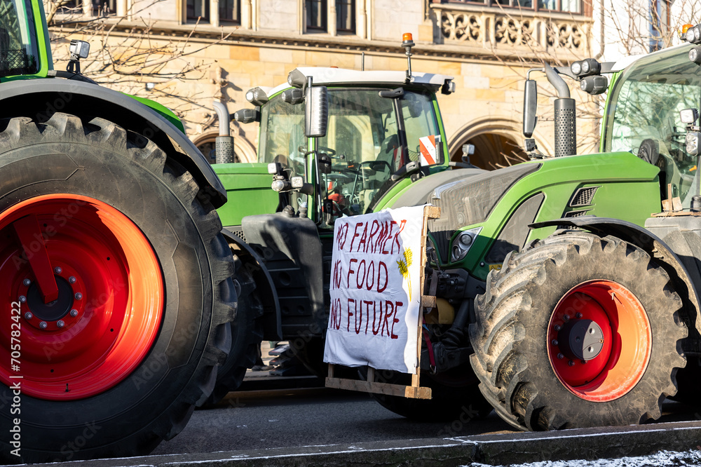 Farmers union protest strike against government Policy in Germany Europe. Tractors vehicles blocks city road traffic. Agriculture farm machines Magdeburg central Breiter weg street - obrazy, fototapety, plakaty 