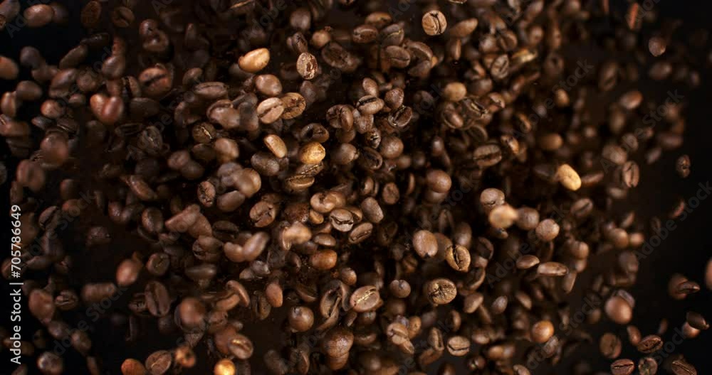Super slow motion macro of fresh flavorful aromatic roasted coffee beans are flying isolated on black background at 1000 fps Super slow motion macro of fresh flavorful aromatic roasted coffee beans are flying isolated on black background at 1000 fps