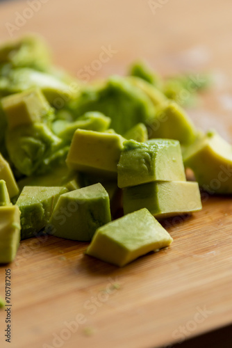 Cut Avocado Cubes Close Up on Wooden Board - Fresh and Tasty Slices