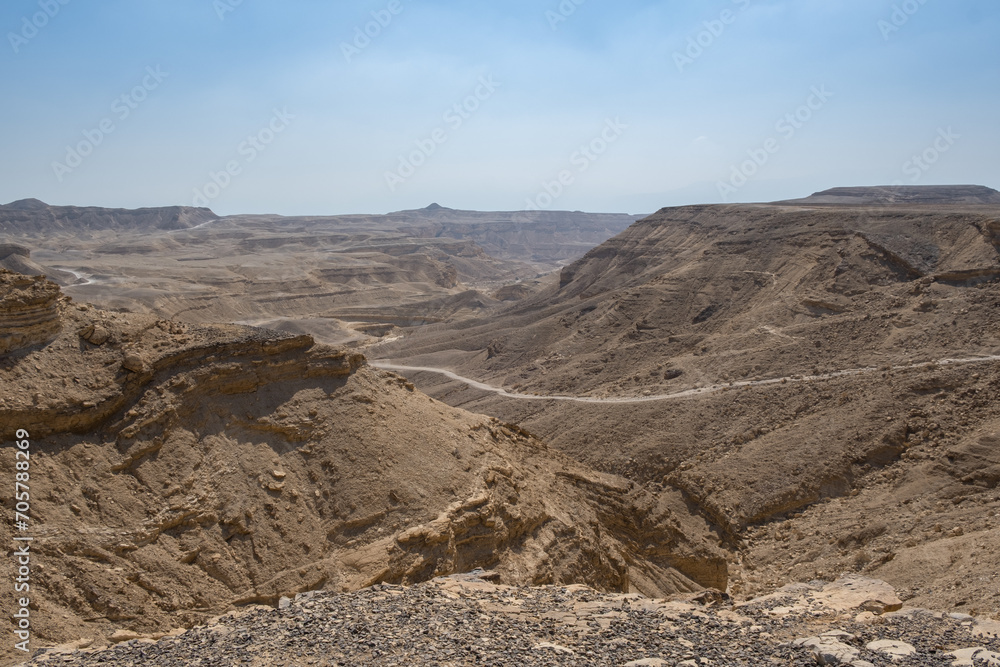 Antique road in Negev Desert in southern Israel during the summer. Desert landscape with volcanic rocks nature