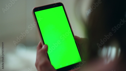 Evening hands holding green screen smartphone closeup. Unknown woman reading sms