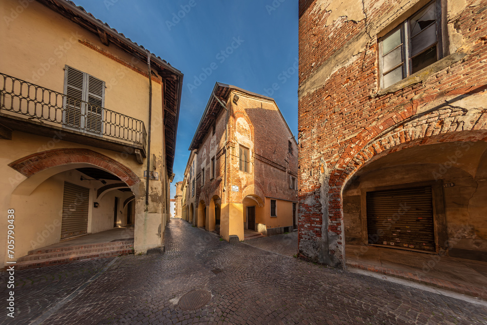 Carignano, Turin, Italy - November 11, 2023: old houses with arcades on Via Vittorio Veneto in the district of medieval origin called Isola di San Giovanni
