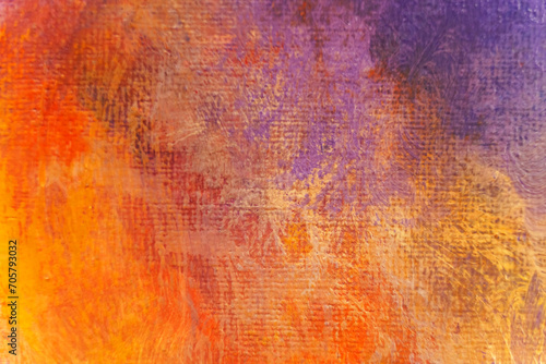 Bright texture of canvas painted in orange-yellow-violet colors with shades.