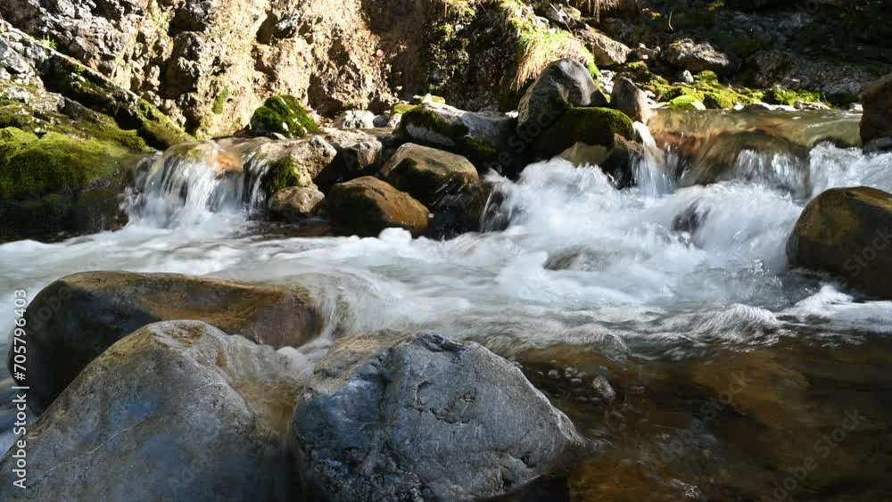 Water flowing over rocks of a mountain stream in autumn Water flowing over rocks of a mountain stream in autumn