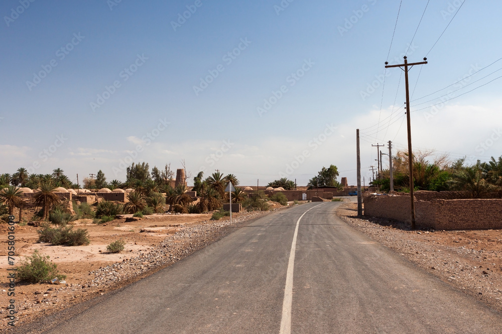 Road through iranian village in desert Lut, near Shahdad city. Iran.