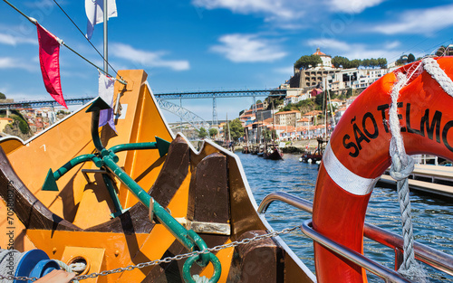 Navigation on the Douro river, in the background the Luis I Bridge, one of the symbols of the city of Porto in Portugal. photo