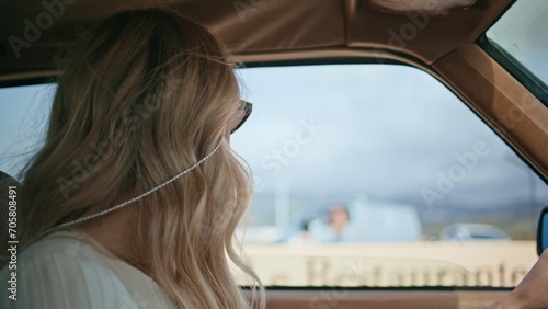 Gorgeous woman driving car in sunglasses close up. Girl riding on retro auto